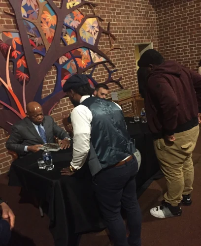 Congressman John Lewis speaking with attendees at a reception