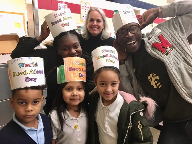 Elementary students and mentors celebrating books during the literacy program