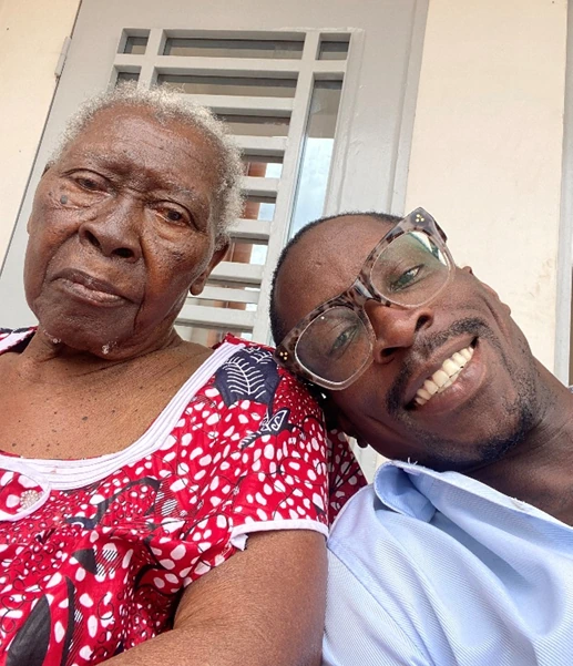 Rick Tamno with his 107-year-old great-grandmother during a 2022 homecoming visit to Cameroon.